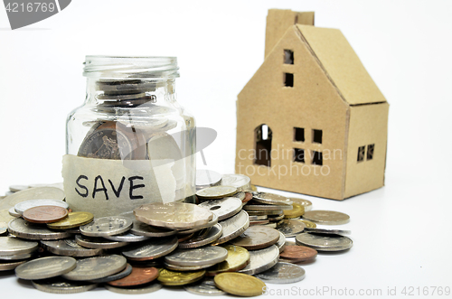 Image of Coins in jar with paper house