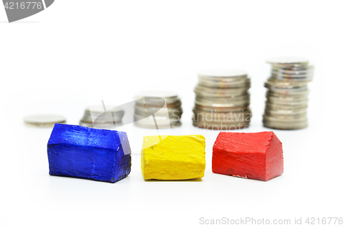 Image of Coins Stacked up in piles with color house