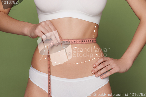 Image of Women belly with the drawing arrows