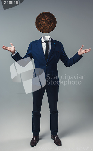 Image of Businessman with an coin instead of his head