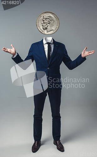 Image of Businessman with an coin instead of his head