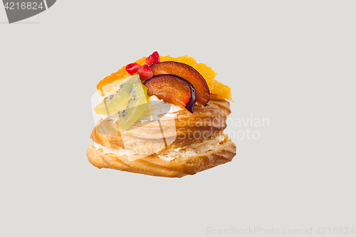 Image of Closeup of cake with fresh fruits on gray background.