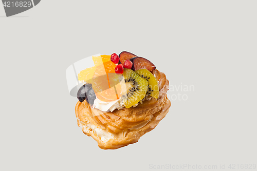 Image of Closeup of cake with fresh fruits on gray background.