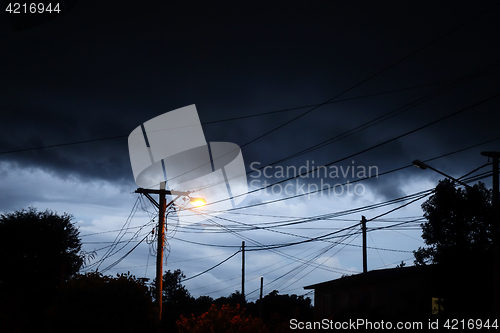 Image of Street light at night with a stormy sky background