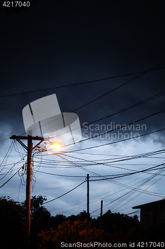 Image of Street light at night with a stormy sky background