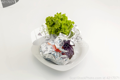 Image of Meat with vegetables baked in aluminum foil