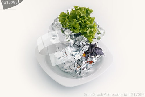 Image of Meat with vegetables baked in aluminum foil