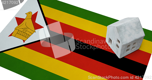 Image of Small house on a flag - Zimbabwe