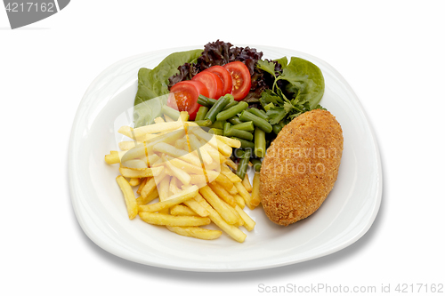 Image of chicken cutlet with vegetables and garnish