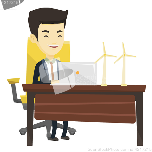 Image of Man working with model of wind turbines.
