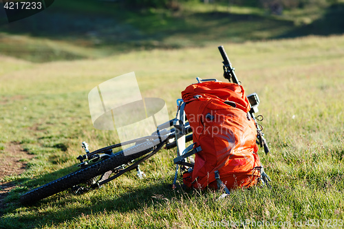 Image of Bicycle with orange bags for travel