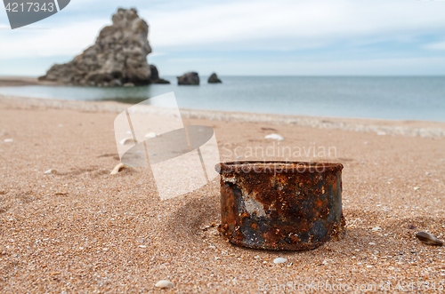 Image of Rusty tin can on the beach