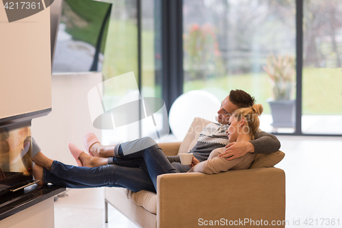 Image of Young couple  in front of fireplace