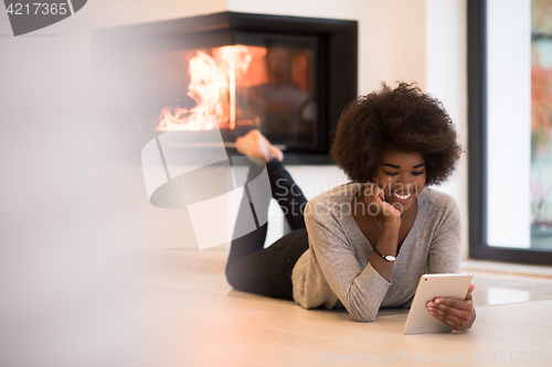 Image of black women using tablet computer on the floor