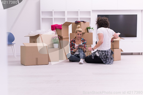 Image of young couple moving  in new house