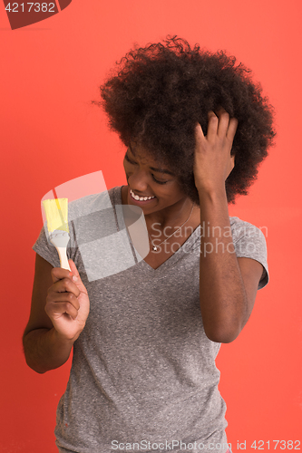 Image of black woman painting wall