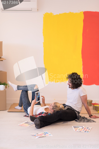 Image of Happy young couple relaxing after painting