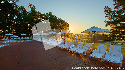 Image of Relaxing chairs beside swimming pool
