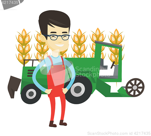 Image of Farmer standing with combine on background.