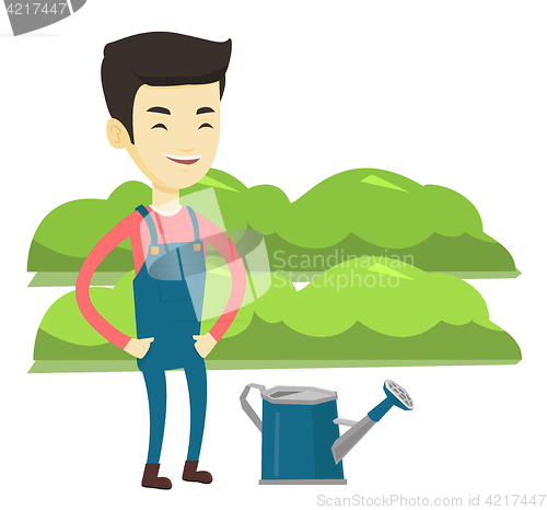 Image of Farmer with watering can at field.