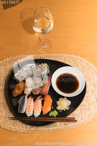 Image of Sushi meal with white wine