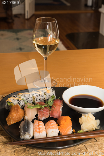 Image of Glass of white wine and sushi