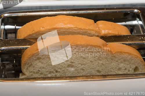 Image of White bread slices in a toaster