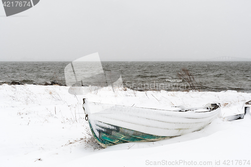 Image of Vintage rowing boat in snow