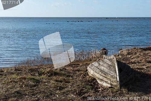 Image of Abandoned rowboat by the coast