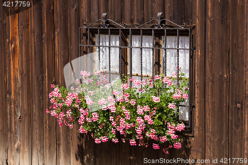 Image of Window and rough wooden walls with flowers in traditional wabi-s