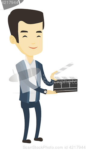 Image of Smiling man holding an open clapperboard.