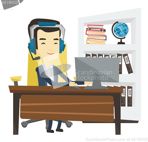 Image of Business man with headset working at office.