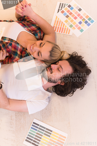 Image of Happy young couple relaxing after painting