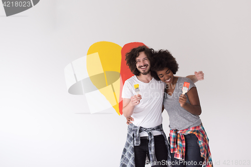 Image of couple with painted heart on wall