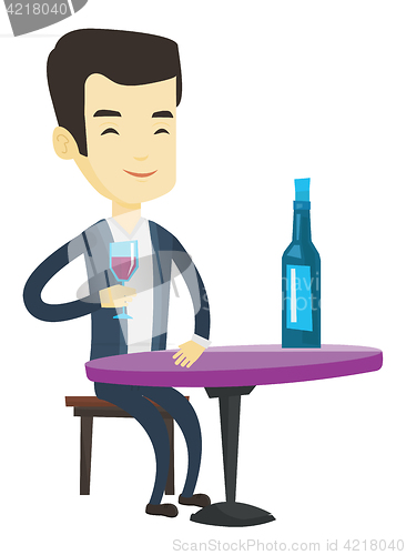 Image of Man drinking wine at restaurant.