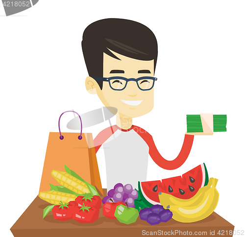 Image of Man standing at the table with shopping bag.