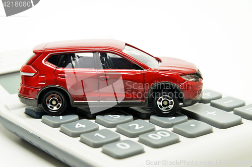 Image of Calculator and red toy car