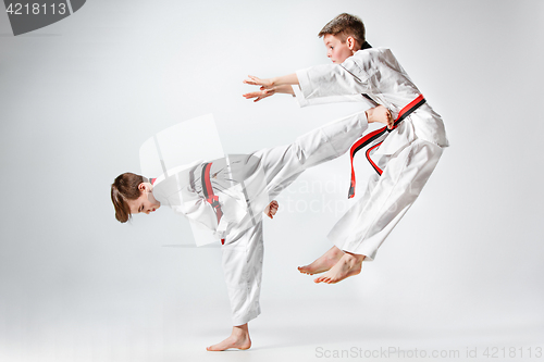 Image of The studio shot of group of kids training karate martial arts