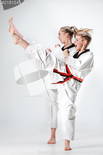 Image of The studio shot of group of kids training karate martial arts