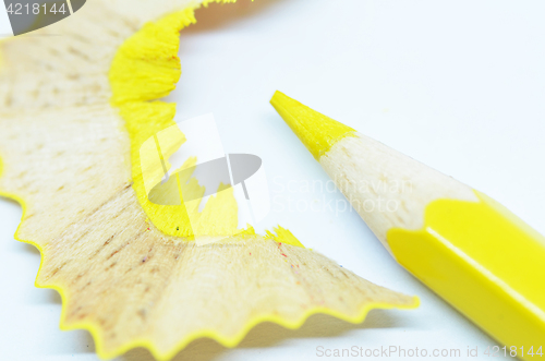 Image of Sharpened yellow color pencil and wood shavings