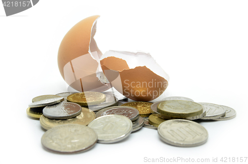 Image of Cracked egg shell and coins 