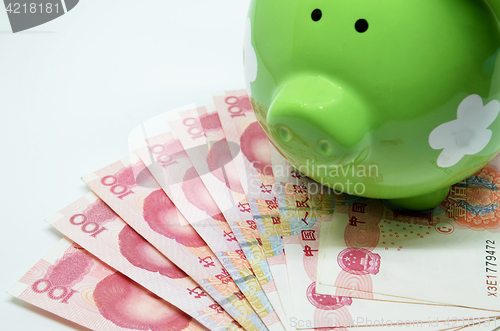 Image of Green piggy bank with China currency