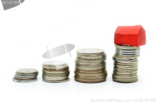 Image of Coins stacked up in piles with color house