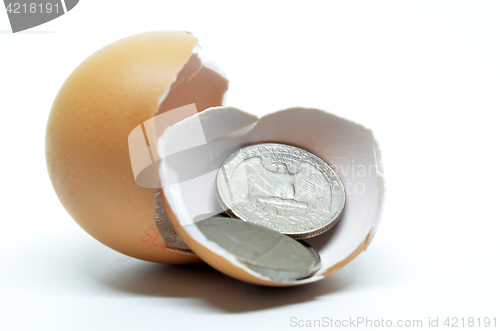 Image of Cracked egg shell and coins