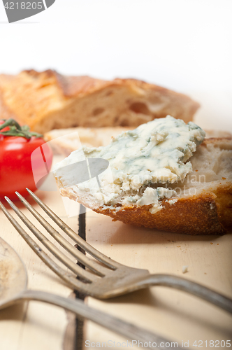 Image of fresh blue cheese spread ove french baguette