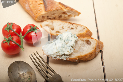 Image of fresh blue cheese spread ove french baguette