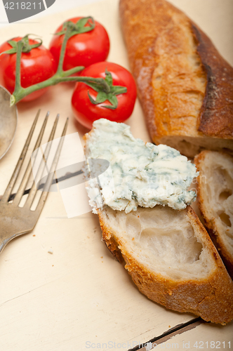 Image of fresh blue cheese spread ove french baguette