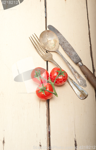Image of ripe cherry tomatoes over white wood