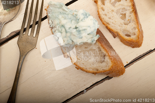 Image of fresh blue cheese spread ove french baguette