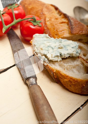 Image of fresh blue cheese spread ove french baguette